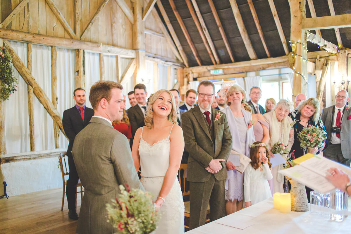 bride-and-groom-say-wedding-vows-clock-barn-wedding-venues-hampshire.jpg
